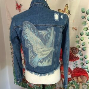 Upcycled small denim jacket with a band logo stitched on the back.